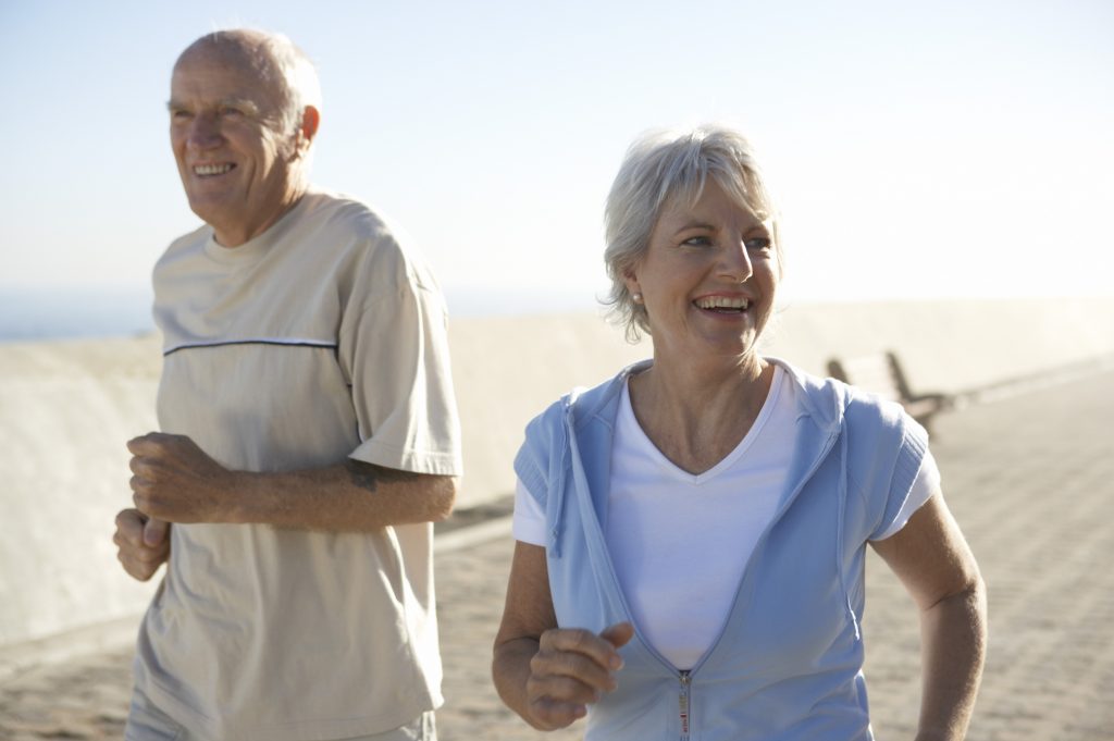 older couple jogging together outside