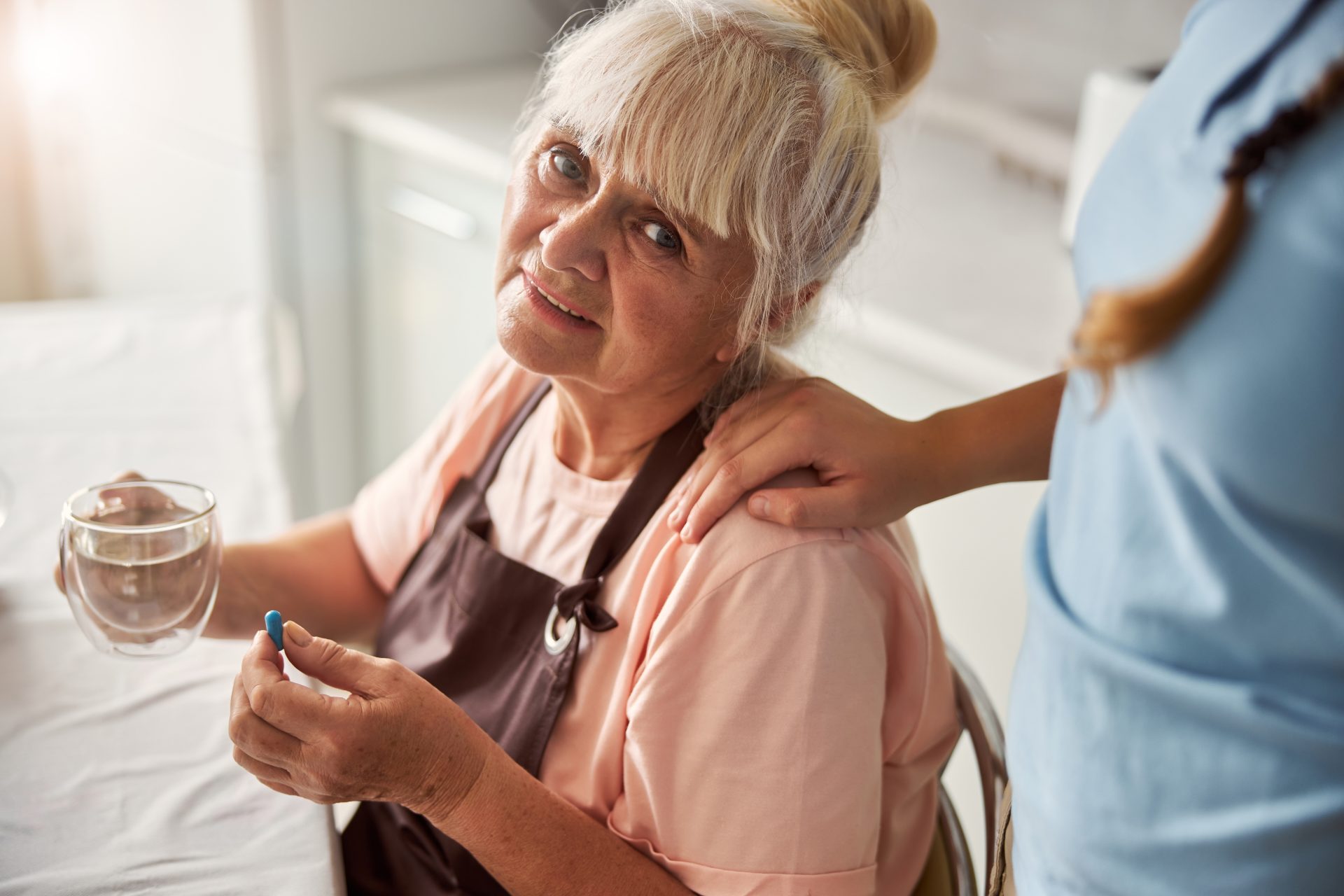 elderly parent refuses to take medication while a daughter lovingly assures their parent 